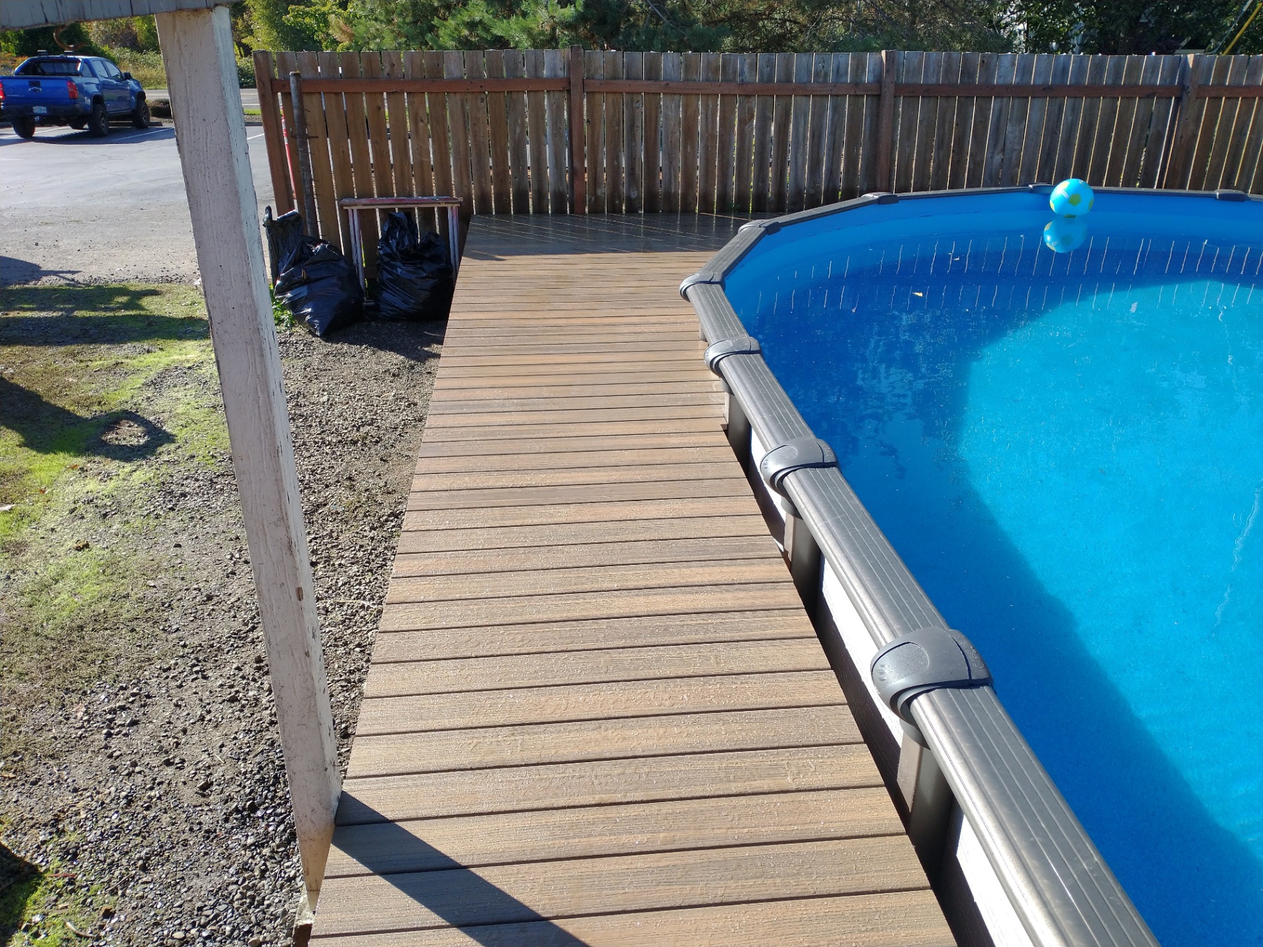 Narrow composite deck walkway alongside an above-ground pool in Dayton, Oregon