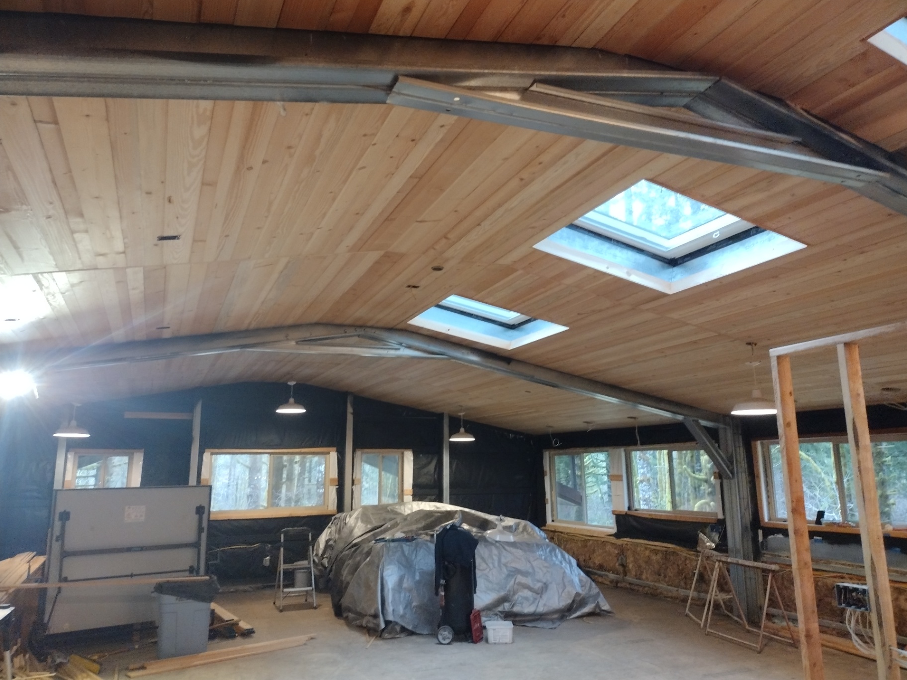Attic remodel with light cedar plank vaulted ceiling and skylights in NW Oregon