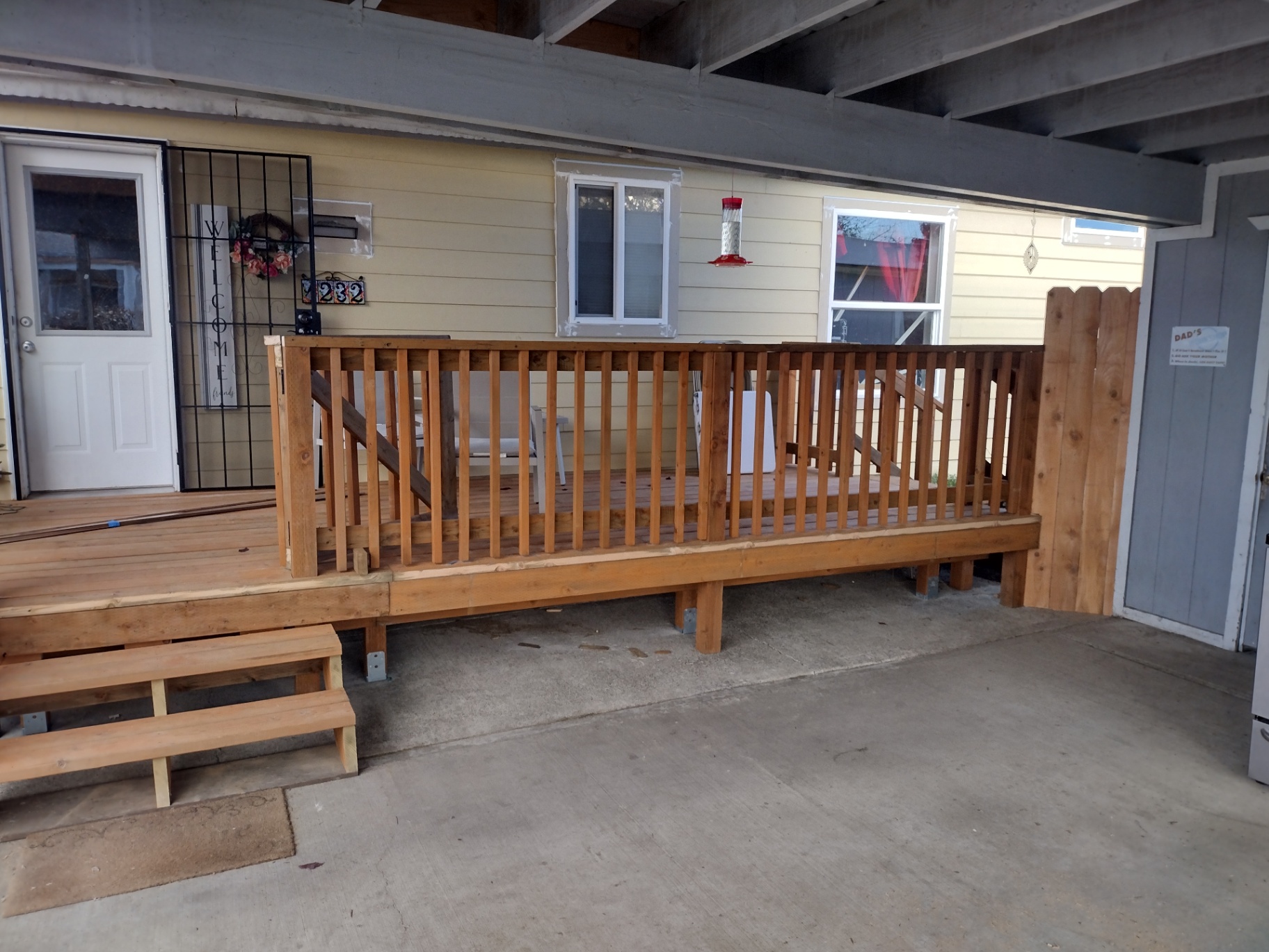 Covered wooden deck with vertical slat cedar railing built in Newberg, Oregon